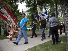Veteran Rob Allan carries the Regina Police Service Eagle Staff as part of the Grand Entry during the National Indigenous Peoples Day celebrations in Victoria Park and City Square Plaza on Tuesday, June 21, 2022 in Regina.