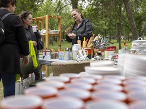 Ada Bennett, right, managing director of YQR Vintage Market, speaks with customers at the first ever Veggies & Vintage Market — a collaboration between the Regina Farmers’ Market and YQR Vintage Market.