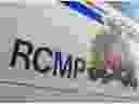 The RCMP logo is seen in this photo of the side of a police vehicle.
