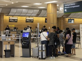 Travellers get their boarding passes at the Regina International Airport on Friday, July 22, 2022 in Regina.