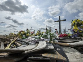 Hockey sticks, messages and other items were on display at a memorial for the Humboldt Broncos bus crash victims at the intersection of Highways 35 and 335 on Aug. 1, 2018.
