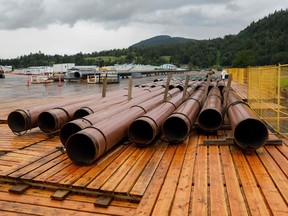 In this file photo taken on June 06, 2021 pieces of the Trans Mountain Pipeline project sit in a storage lot outside of Abbotsford, British Columbia, Canada.(Photo by Cole Burston / AFP)