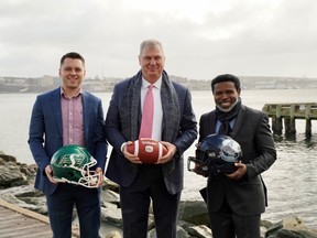 Saskatchewan Roughriders placekicker Brett Lauther (left), CFL commissioner Randy Ambrosie and Toronto Argonauts general manager Michael (Pinball) Clemons were in Wolfville, N.S., on March 29 to announce that Touchdown Atlantic will be played in that town on Saturday.