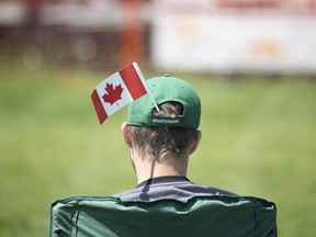 A Canadian flag hangs in an attendees hat during Canada Day celebrations at Wascana Park on Friday, July 1, 2022 in Regina.