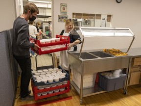 Carmichael Outreach food services and operations manager Tyler Gelsinger, left, and volunteer Noma Yurkiw prepare for lunch for clients on Monday, July 25, 2022 in Regina.