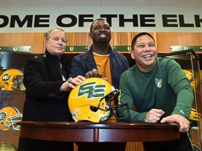 Unveiling the return to the double E helmet design are, from left, Dan McKinnon, former assistant coach, Mookie Mitchell, former receiver and now EE Football Alumni Association President and Victor Cui, Edmonton Elks President and CEO at Commonwealth Stadium in Edmonton, March 3, 2022. Ed Kaiser/Postmedia