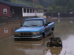 Receded water levels from the North Fork of the Kentucky River surround a truck in downtown Jackson on July 30, 2022 in Jackson, Kentucky.