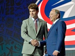 Moose Jaw Warriors defenceman Denton Mateychuk shakes hands with NHL commissioner Gary Bettman on Thursday in Montreal after being selected 12th overall by the Columbus Blue Jackets.