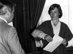 In this archival photo, JoAnn Wilson, former wife of ex-Saskatchewan minister Colin Thatcher, talks with her lawyer, Gerry Gerrand, on July 13, 1981 before a news conference where she announced she was giving up custody of her son Regan. Wilson's arm had been in a steel brace since being shot by an unknown person May 17 of the same year.