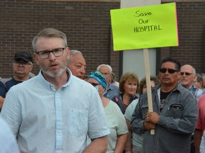 Rural and Remote Health Minister and Canora-Pelly MLA Terry Dennis speak with people outside the Kamsack Hospital following rallies on Thursday protesting service reductions.