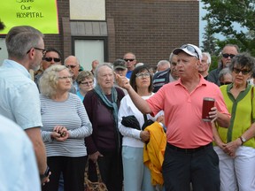 People concerned about service reductions at the Kamsack Hospital speak with Rural and Remote Health Minister Everett Hindley (in light shirt and glasses, far left) on Thursday during a protest.