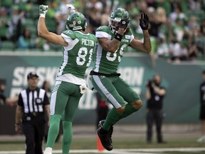 Saskatchewan Roughriders receiver Mitchell Picton, 81, and Kian Schaffer-Baker, 89, celebrate Schaffer-Baker's touchdown against the Montreal Alouettes on July 2, 2022.