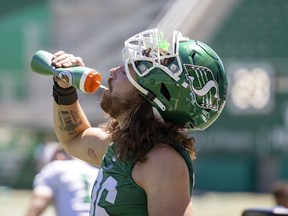 Roughriders defensive end Nicholas Dheilly takes a drink during Tuesday's weltering practice at Mosaic Stadium on Tuesday, July 12, 2022 in Regina.