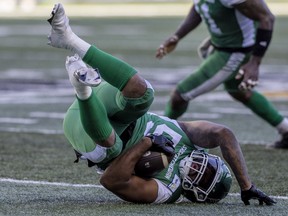 Saskatchewan Roughriders linebacker Darnell Sankey falls to the Mosaic Stadium turf after making a leaping interception Sunday against the Toronto Argonauts.