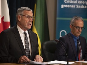 Minister Responsible for SaskEnergy Don Morgan sits beside Acting President and CEO of SaskEnergy Mark Guillet during a press conference for the annual SaskEnergy report.