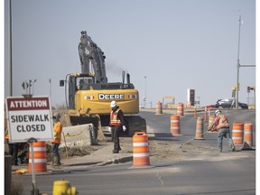 Construction crews work on a overpass on Winnipeg street that directs traffic over Ring Road north.