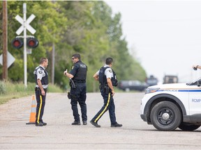 RCMP and other police vehicles are gathered on Park Avenue, north of the railway crossing, in Langham Sask., where one person has been reported dead.