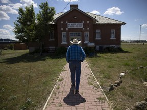 Mayor of Val Marie Roland Facette walks towards the former Val Marie school where he attended as a child, which is now a museum on Tuesday, July 19, 2022 at Val Marie.