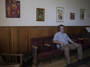 The Convent Inn bed and breakfast owner Adam Ducan sits in a common room for a portrait.