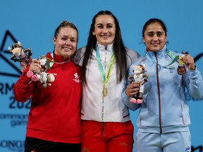 Left to right: Canada's Alexis Ashworth (silver), England's Sarah Davis (gold) and India's Harjinder Kaur of Team India (bronze) on the podium after the Commonwealth Games women's 71 kg weightlifting event in Birmingham, England on Monday. is shown.  ,