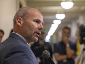 Education Minister Dustin Duncan speaks to reporters about enhanced regulations for qualified independent schools at the Legislative Building on Thursday.