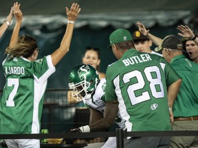 Saskatchewan Roughriders receiver Duke Williams, 5, celebrates with fans after scoring a touchdown Saturday against the host Edmonton Elks. Williams was subsequently fined by the CFL for violating the league's security policy.