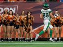 Saskatchewan Roughriders slotback Kian Shaffer Baker, 89, passes the BC Lions cheerleaders en route to scoring a first-half touchdown at BC Place. On Friday. 