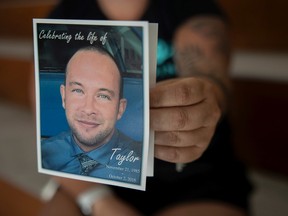 REGINA, SASK : August 31, 2022-- Lauren MacDonald, sister of Taylor MacDonald, a man who died in October of 2018 due to an overdose holds a portrait of her brother during an International Overdose Awareness Day event being held at the Mamaweyatitan Centre on Wednesday, August 31, 2022 in Regina. KAYLE NEIS / Regina Leader-Post