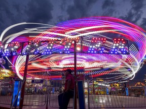 As the sun sets on the Queen City Ex, the lights on the midway make for quite the show on Aug. 4, 2022.