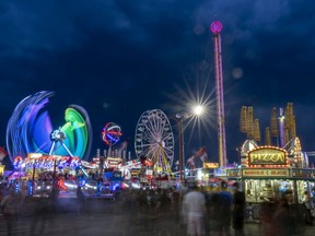 A file photo employing a slow shutter speed to capture motion shows the midway lights at the Queen City Ex on Thursday, August 4, 2022 in Regina, Saskatchewan.