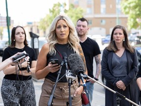 Caitlin Erickson, a lead plaintiff in a class-action suit against the Legacy Christian Academy school, speaks during a press conference in downtown Saskatoon on Aug. 18, 2022.