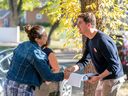 Nathaniel Teed, Saskatchewan NDP candidate for the Saskatoon Meewasin byelection, interacts with a person on byelection day in Saskatoon, Sask. on Monday, September 26, 2022.