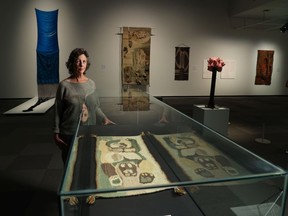 Curator Michele Hardy stands in the new exhibit at the Nickle Galleries called Prairie Interlace: Weaving, Modernisms and the Expanded Frame 1960-2000 on Monday, September 19, 2022. Gavin Young/Postmedia