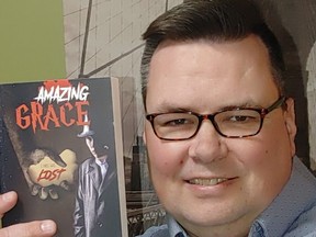 T.D. Zummack of Regina holds up a copy of his new book, Amazing Grace.