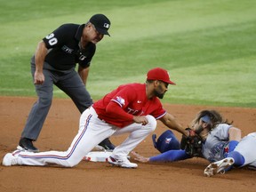 Texas Rangers infielder Marcus Semien tags out Blue Jays’ Bo Bichette on an attempted steal during the first inning of last night’s game in Arlington, Texas. Steals could be a bigger factor in games next season with word yesterday that bases are going to be larger in 2023 while pitchers will be allowed only two pickoff attempts.  Michael Ainsworth/AP