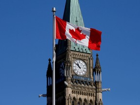 A Canadian flag flies in front of the Peace Tower on Parliament Hill in Ottawa March 22, 2017.