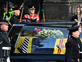The coffin of Queen Elizabeth II arrives from the Palace of Holyroodhouse to St. Giles Cathedral, in Edinburgh, Scotland, Monday, Sept. 12, 2022, where Queen Elizabeth II will lie at rest.
