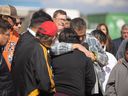 Myrtle Godfrey (right) says a prayer for her nephew who is in hospital during a candle lit vigil at Saskatoon City Hall for all of those affected by the tragedy in James Smith Cree Nation.