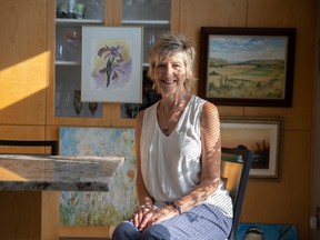 Sherry Wolf sits with some artwork for a sale and fundraiser by Grandmothers 4 Grandmothers on Sept. 17.