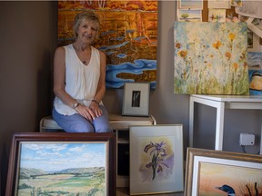 Sherry Wolf sits with some artwork that's part of an upcoming sale and fundraiser by the Regina branch of Grandmothers 4 Grandmothers, a non-profit organization that raises money for the Stephen Lewis Foundation.
