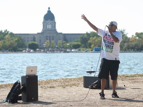 This file photo shows Brad Bellegarde, AKA InfoRed, performing on the side of the walking path in Wascana Park Across the lake from the Saskatchewan Legislative Building in Regina on Sept. 18, 2021. Bellegarde’s performance was part of the first-ever Busker Festival organized in the park, offering artists a chance to interact with passersby.