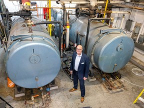 Kevin Saunderson, executive director service innovation, stands by the boilers at the Regina Public Library Central Branch  on Thursday, September 22, 2022 in Regina.