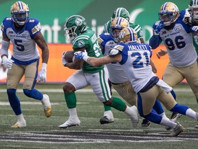 Saskatchewan Roughriders running back Frankie Hickson (20) runs the ball during the Labour Day Classic against the Winnipeg Blue Bombers on Sunday.