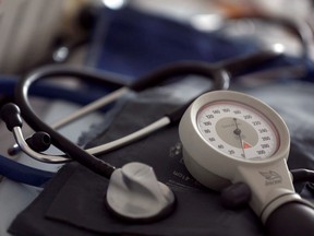 A photo illustration shows a stethoscope and  blood-pressure machine of a general practitioner displayed in a doctor's office.