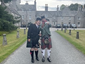 Bethany Bisaillion, left, the Sons of Scotland Pipe Band's pipe major, poses for a selfie with drum major Brian Wilson, outside Scotland's Balmoral Castle in Aberdeenshire on Wednesday Aug. 17, 2022.