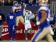 Winnipeg Blue Bombers' Dalton Schoen catches a pass over the Saskatchewan Roughriders' Amari Henderson on Friday. Schoen ended up scoring a 64-yard touchdown.