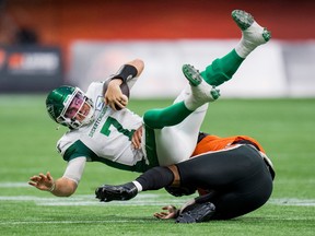 B.C. Lions defensive tackle Sione Teuhema, right, sacks Saskatchewan Roughriders quarterback Cody Fajardo on Aug. 26 at BC Place. Fajardo is, by far, the CFL's most-sacked quarterback in 2022.