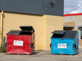 A garbage bin and recycle bin sit out back of a business on Friday, September 9, 2022 in Regina.