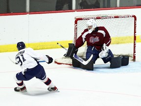 Alex Suzdalev, left, takes a shot during the Regina Pats' Blue and White Game at the Brandt Centre on Tuesday.