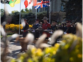 Police and peace officers hold various ceremonial hats for the different forces at the annual Saskatchewan Police and Peace Officers Memorial outside of the Saskatchewan Legislative Building on Sept. 25, 2022 in Regina.